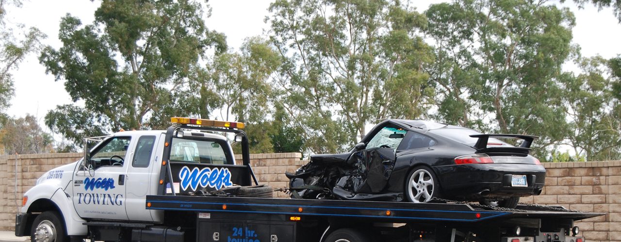 Flatbed Tow Truck Towing A Black Car