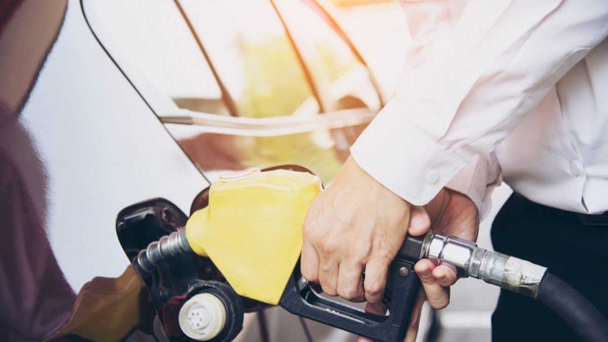 man putting fuel on his car