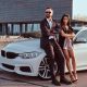 couple with their high-end vehicle