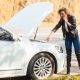 blonde woman on the side of the road with a broken car