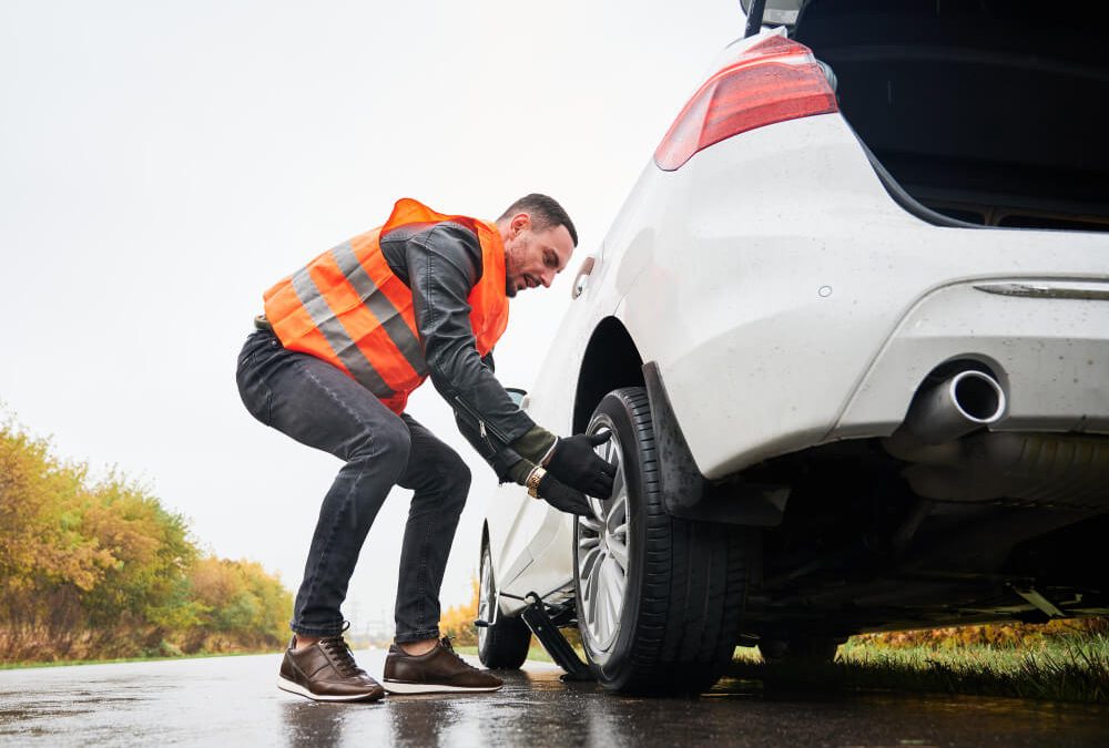 man changing his flat tire