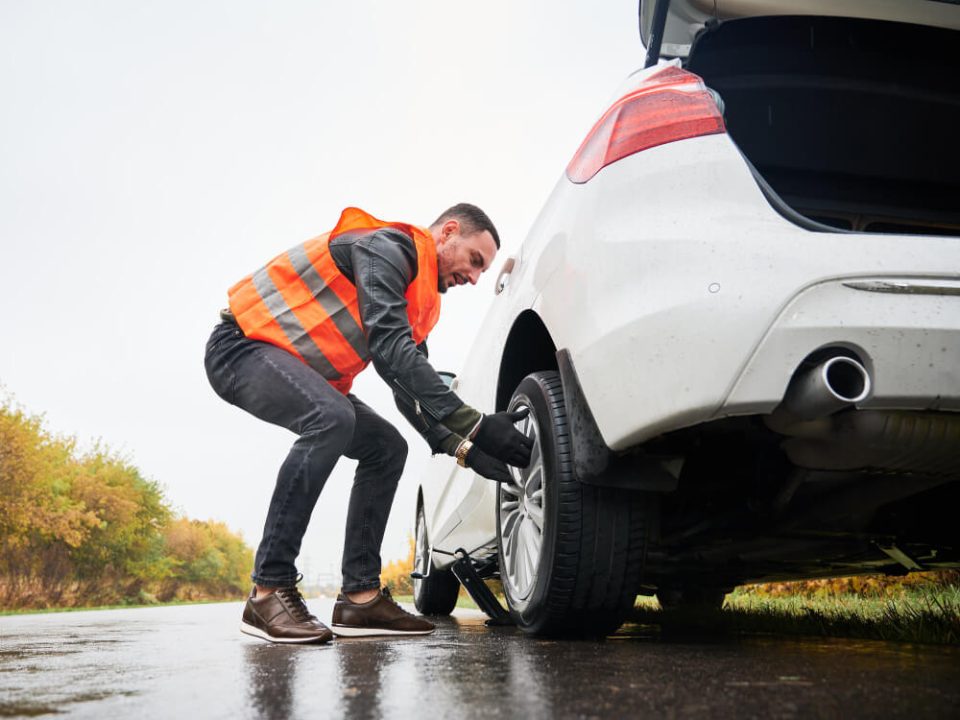 man changing his flat tire
