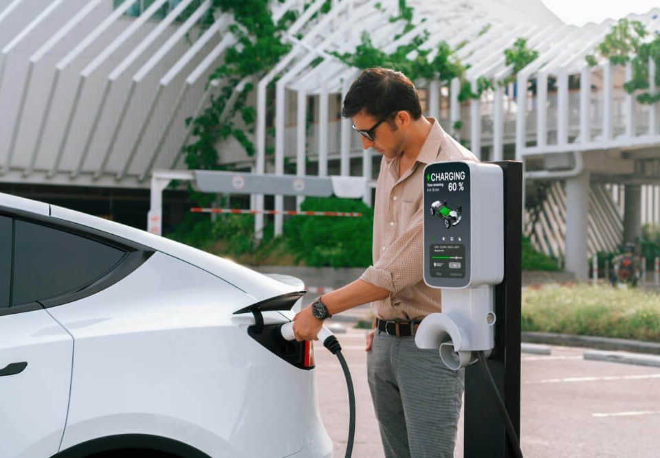 man charging his electric vehicle