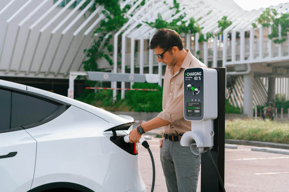 man charging his electric vehicle